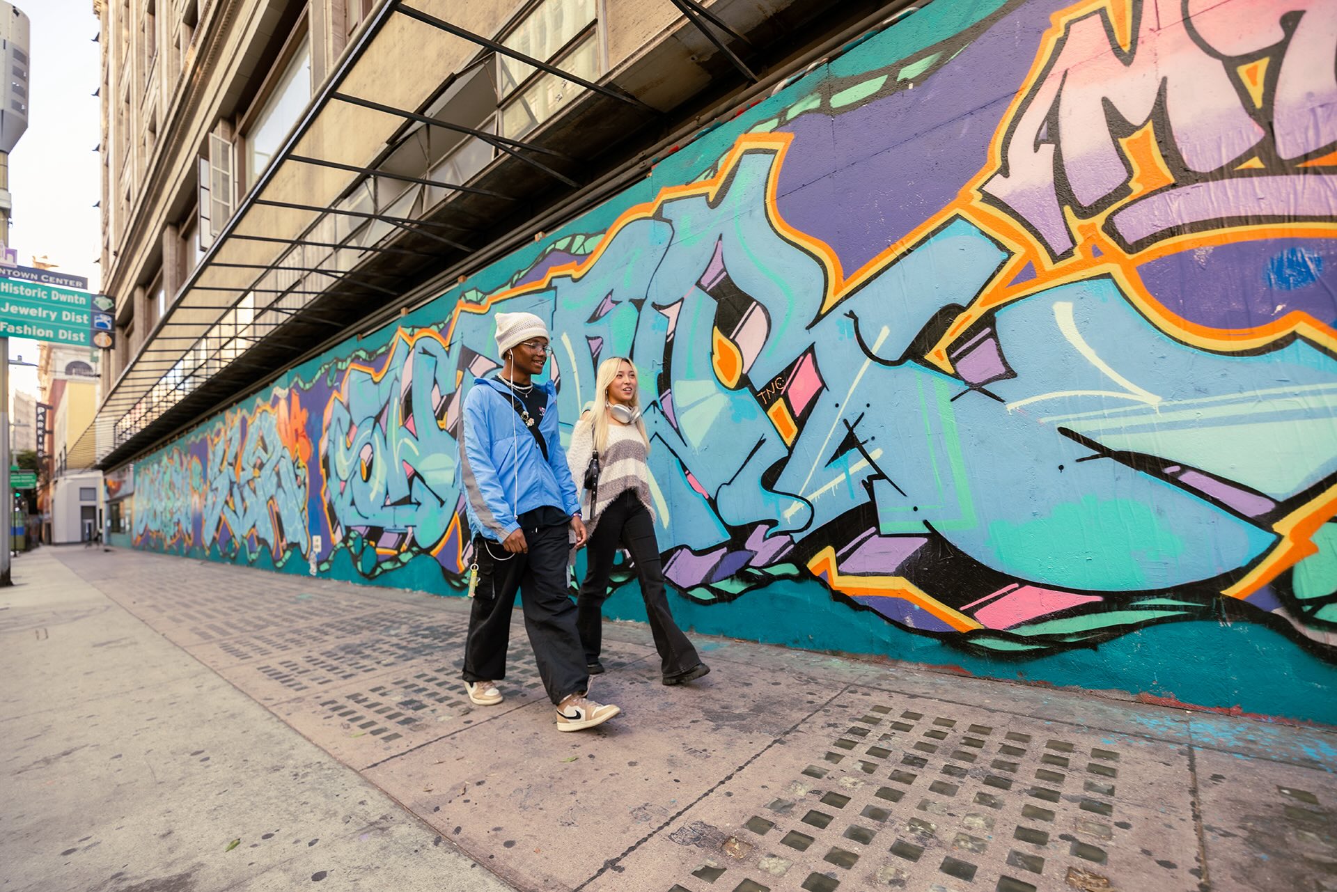 Two students walking together around the city.