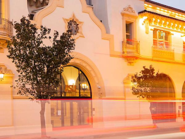 Entrance to California Broadway building at night.