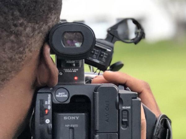 Person filming with camera.
