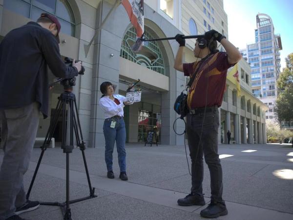 Students filming a project on campus.