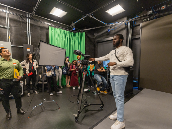 Group of people in a news studio environment.